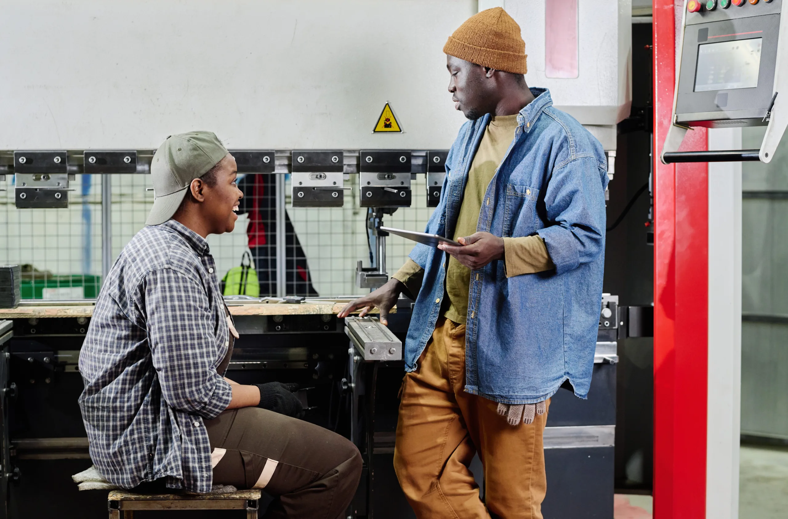 Colleagues discussing plan of work at factory